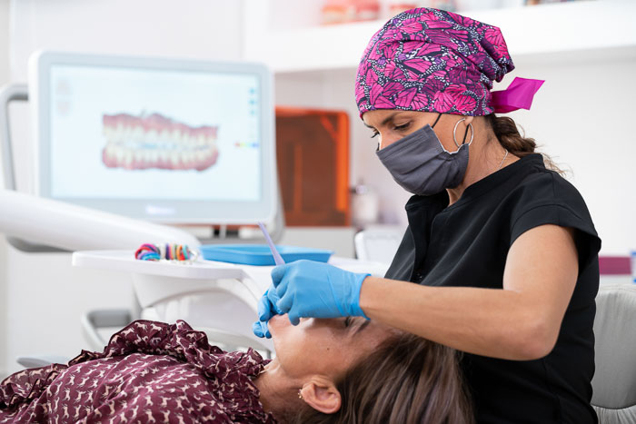 A patient is having a dental consultation in Mexico with a female doctor.