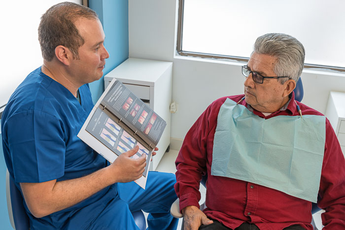 The Doctor explains to a patient about dental crowns in Mexico.