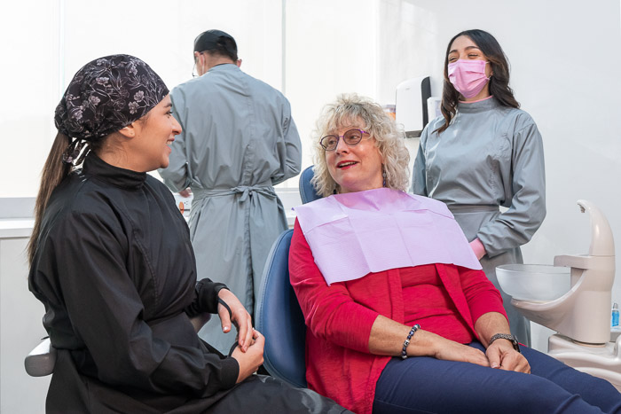 Patient and dentist in Mexico finishing details on the full smile makeover treatment.