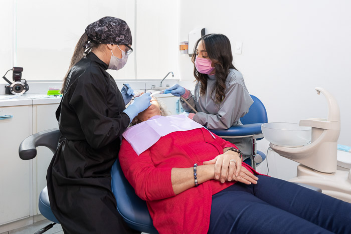 The dentist in Mexico is working on a full smile makeover patient.