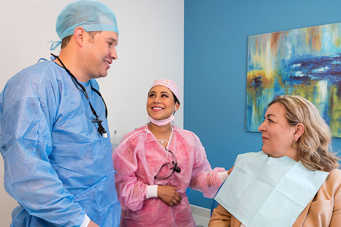 The doctors and the patient are talking about dental crowns in Mexico.