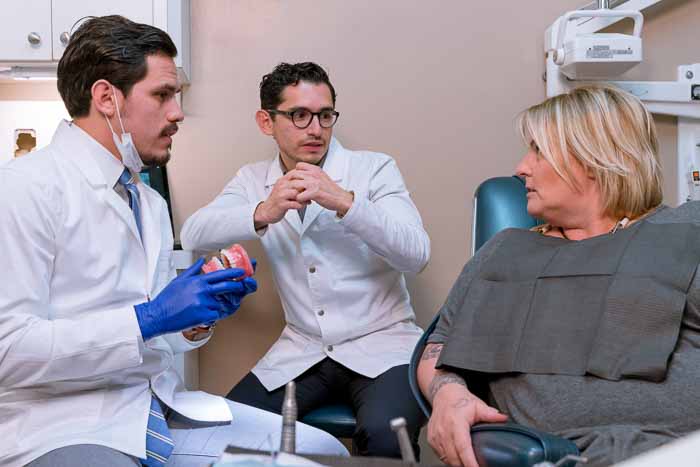 Dentists in Mexico talking with the patient.