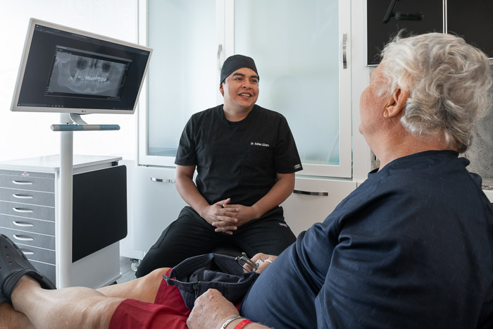 Dentist explaining all-on-four-procedure