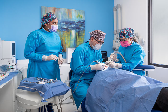 Doctors performing Bone grafting surgery on patient