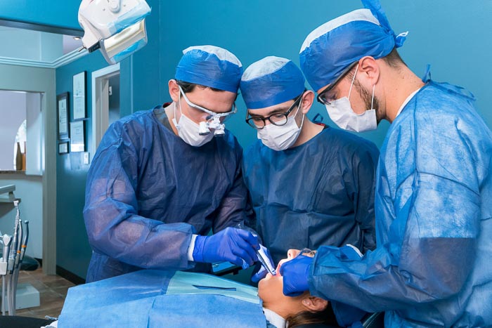 Doctors performing Bone grafting surgery on patient